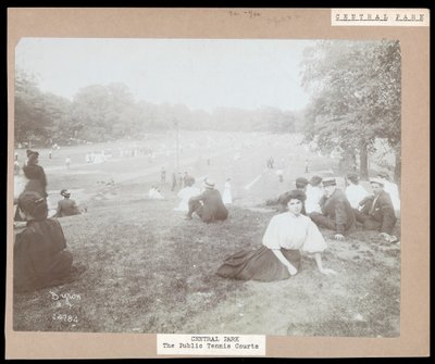 View of men and women seated on grass watching lawn tennis in Central Park, New York, c.1917 by Byron Company